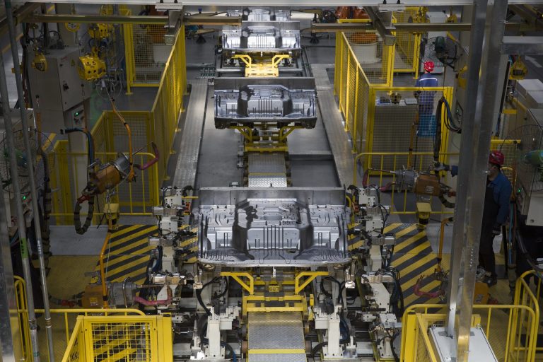 Robots and yellow safety fencing on the FOTON Tunland body assembly line in China